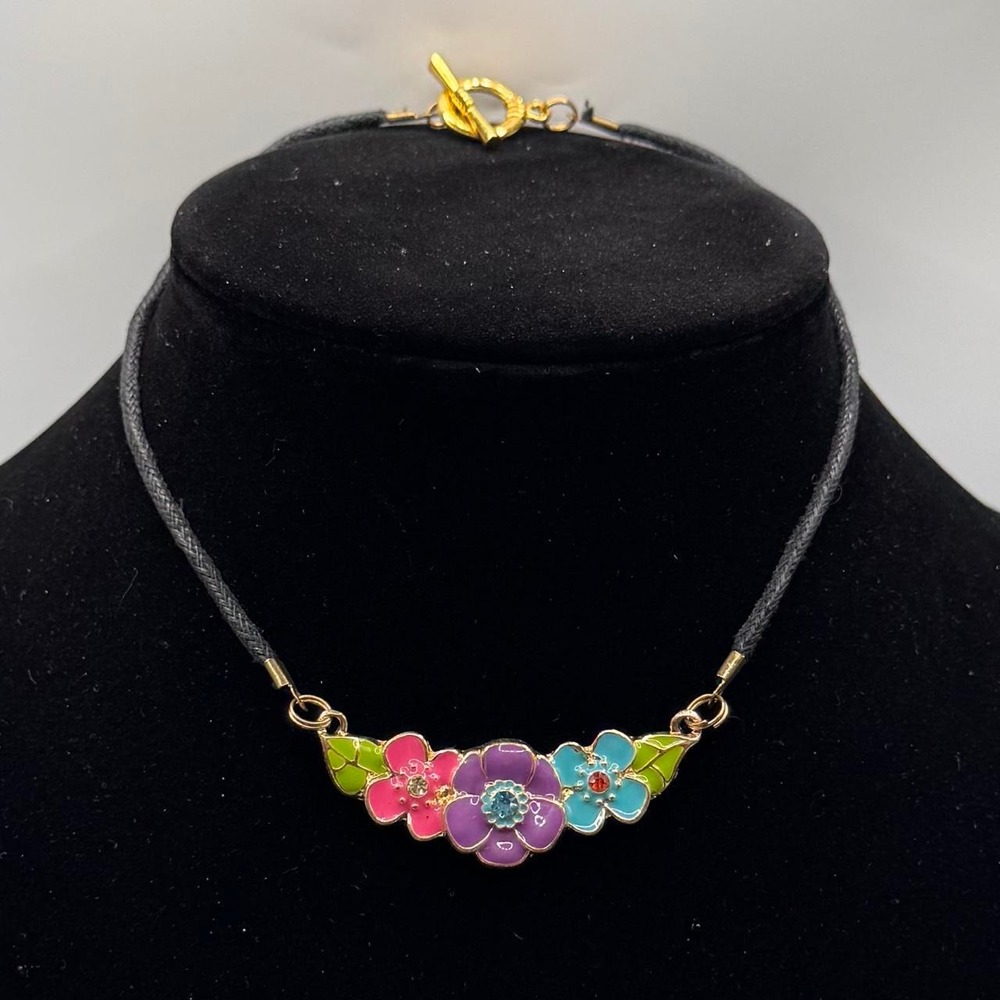 Enamel flower necklace with pink, purple, and blue flowers with green leaves